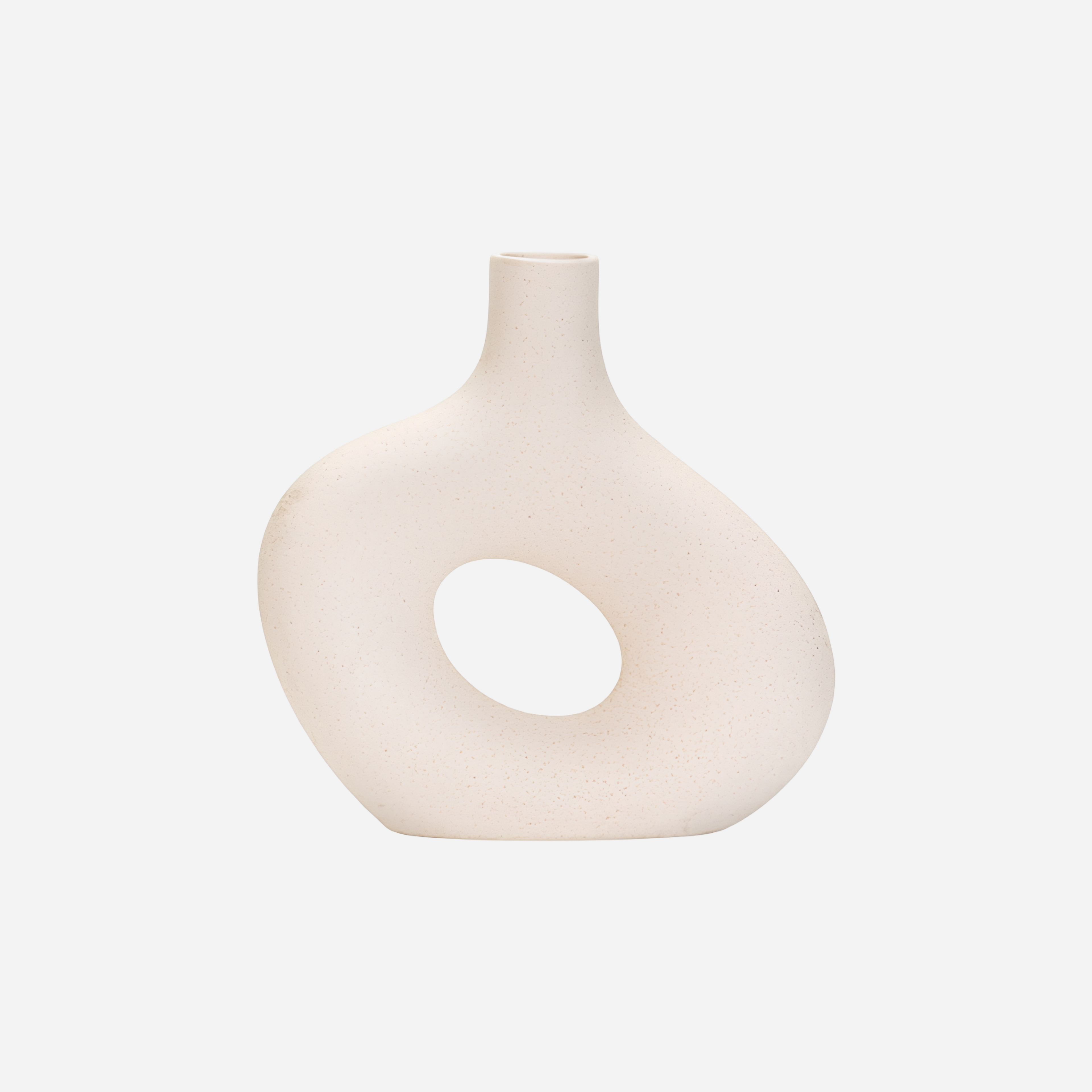 White vase with a circular design on a light gray background