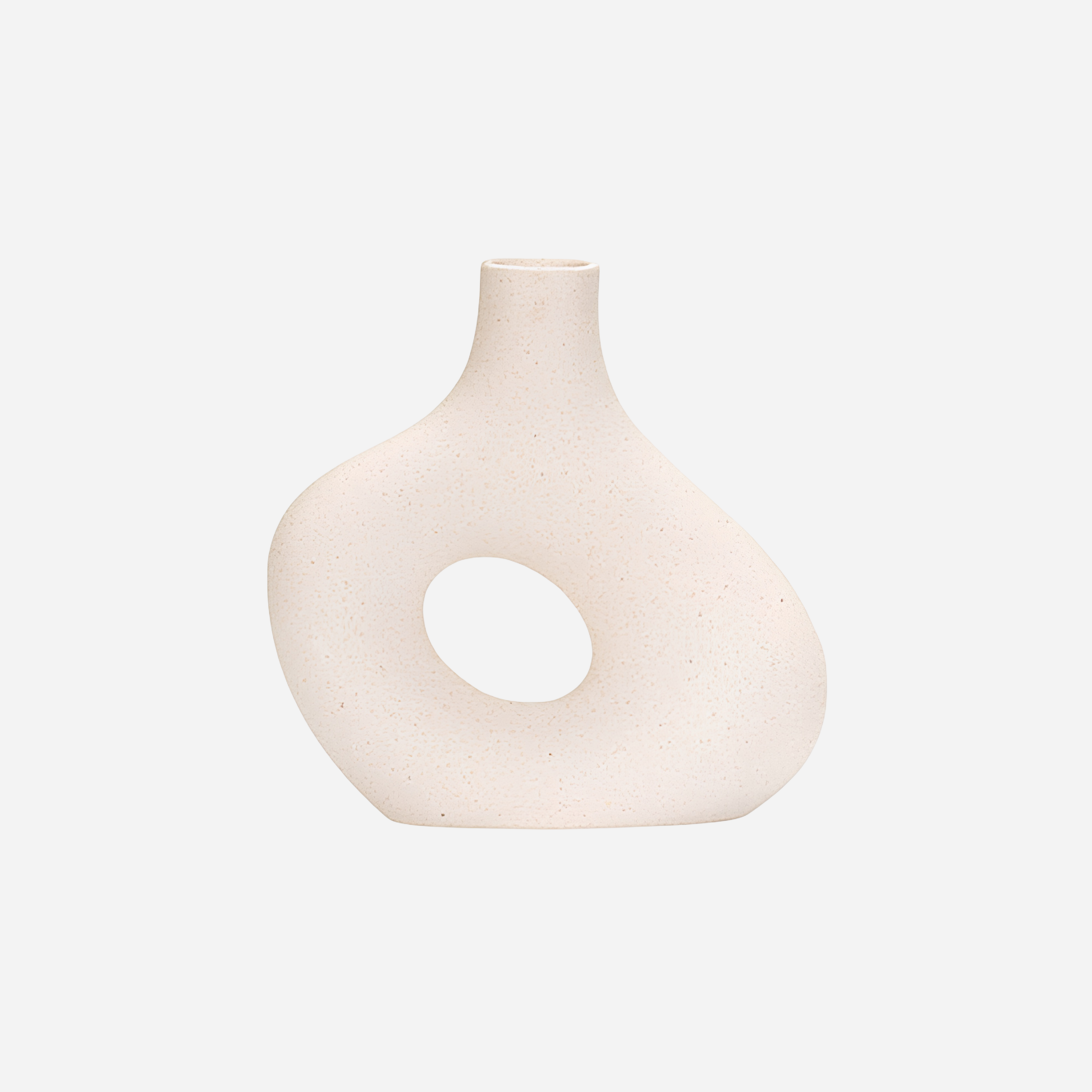 White ceramic vase with a circular hole on a light gray background