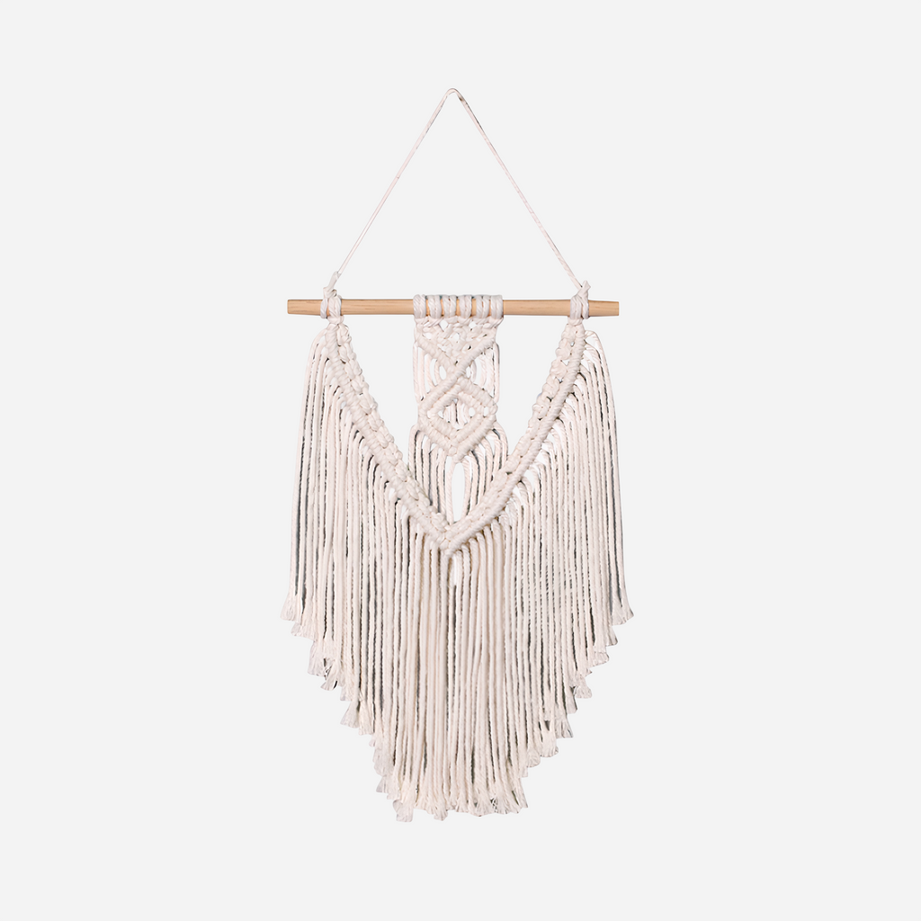 Macrame wall hanging with wooden rod on a white background