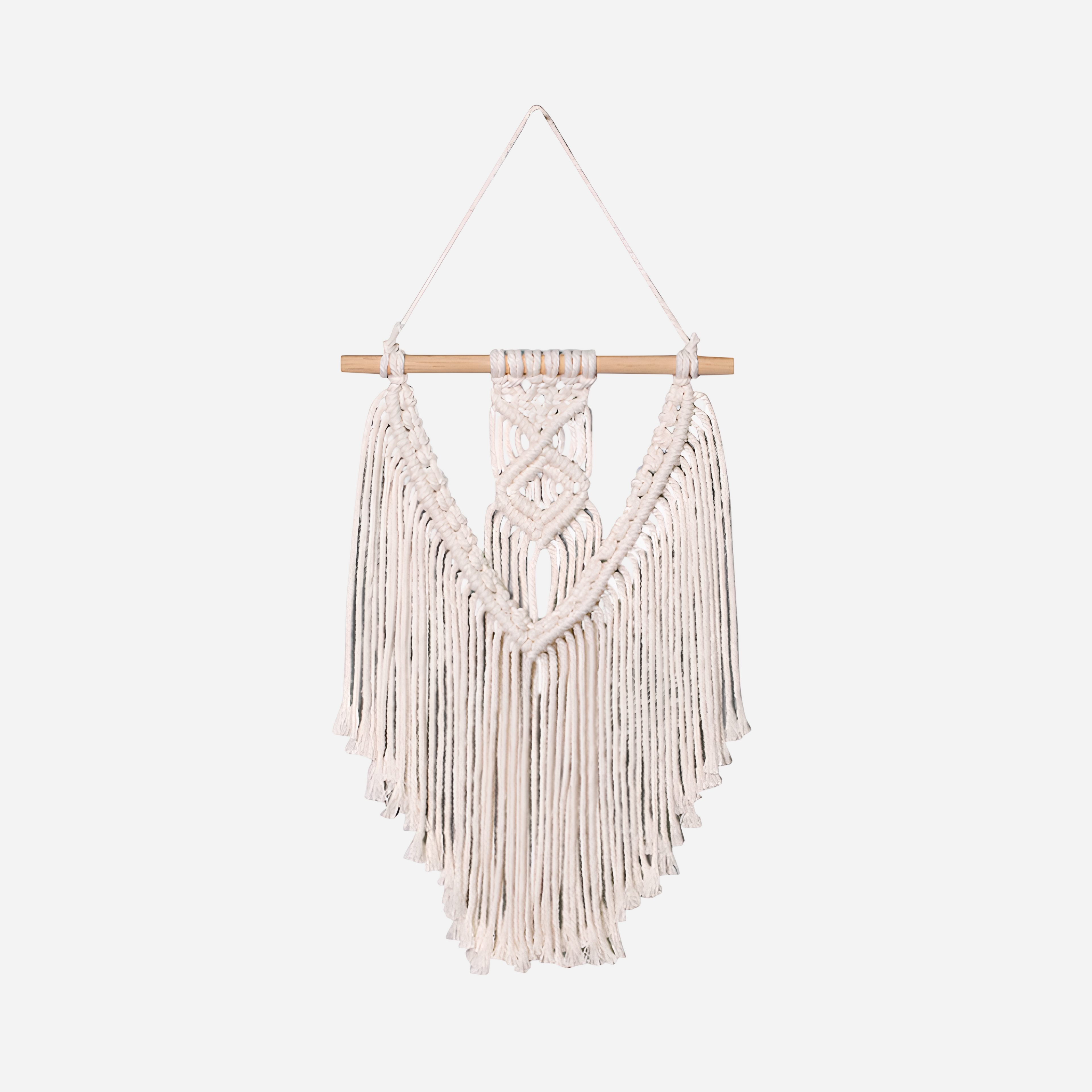 Macrame wall hanging with wooden rod on a white background
