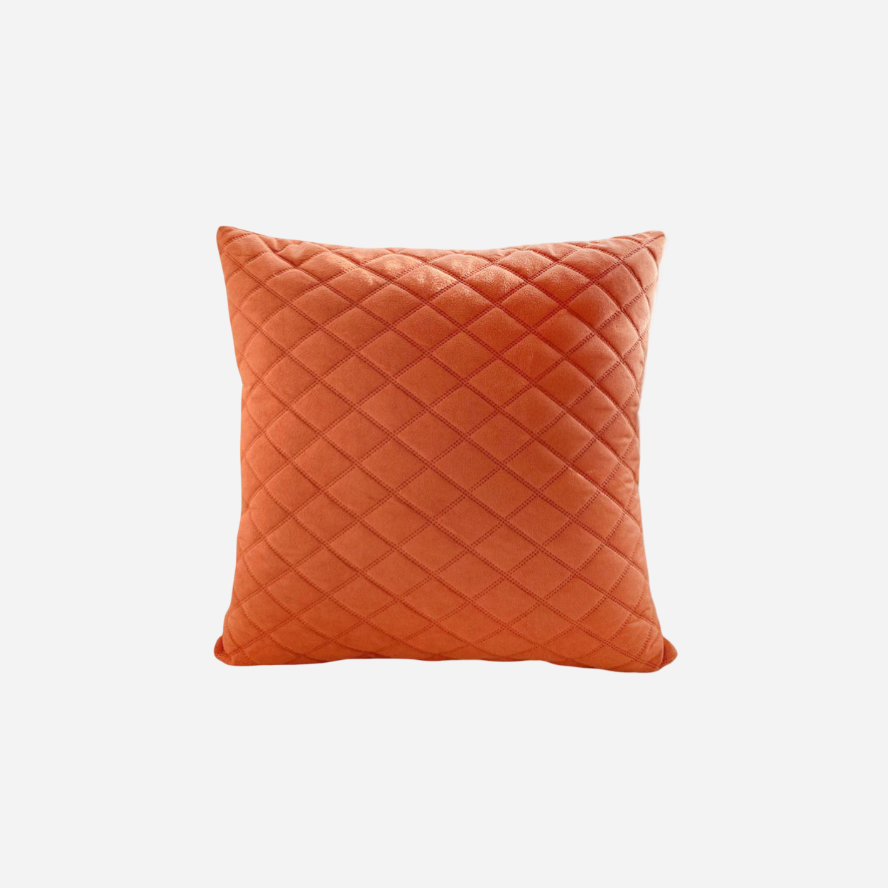 Orange quilted pillow on a white background
