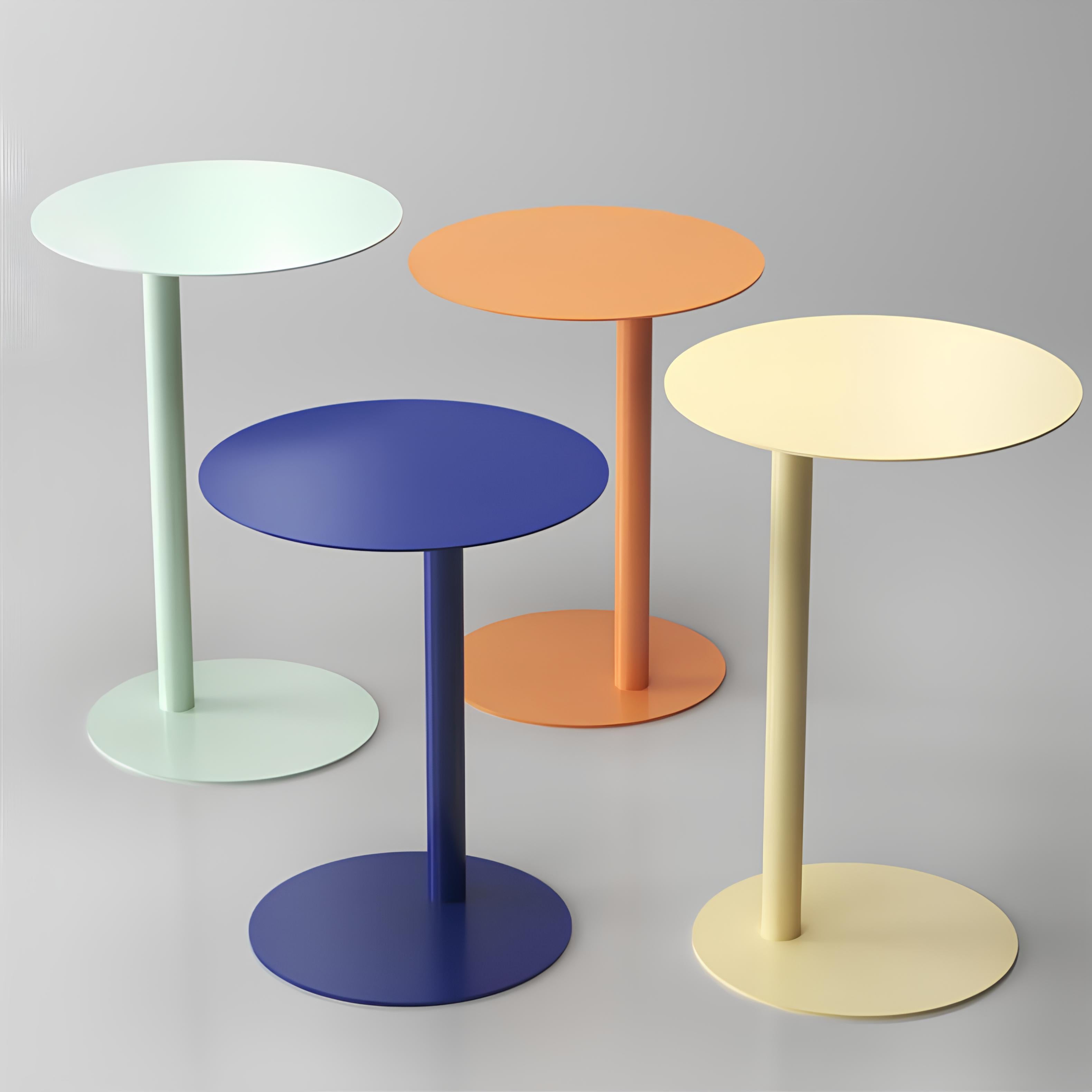 Four colorful side tables on a gray background