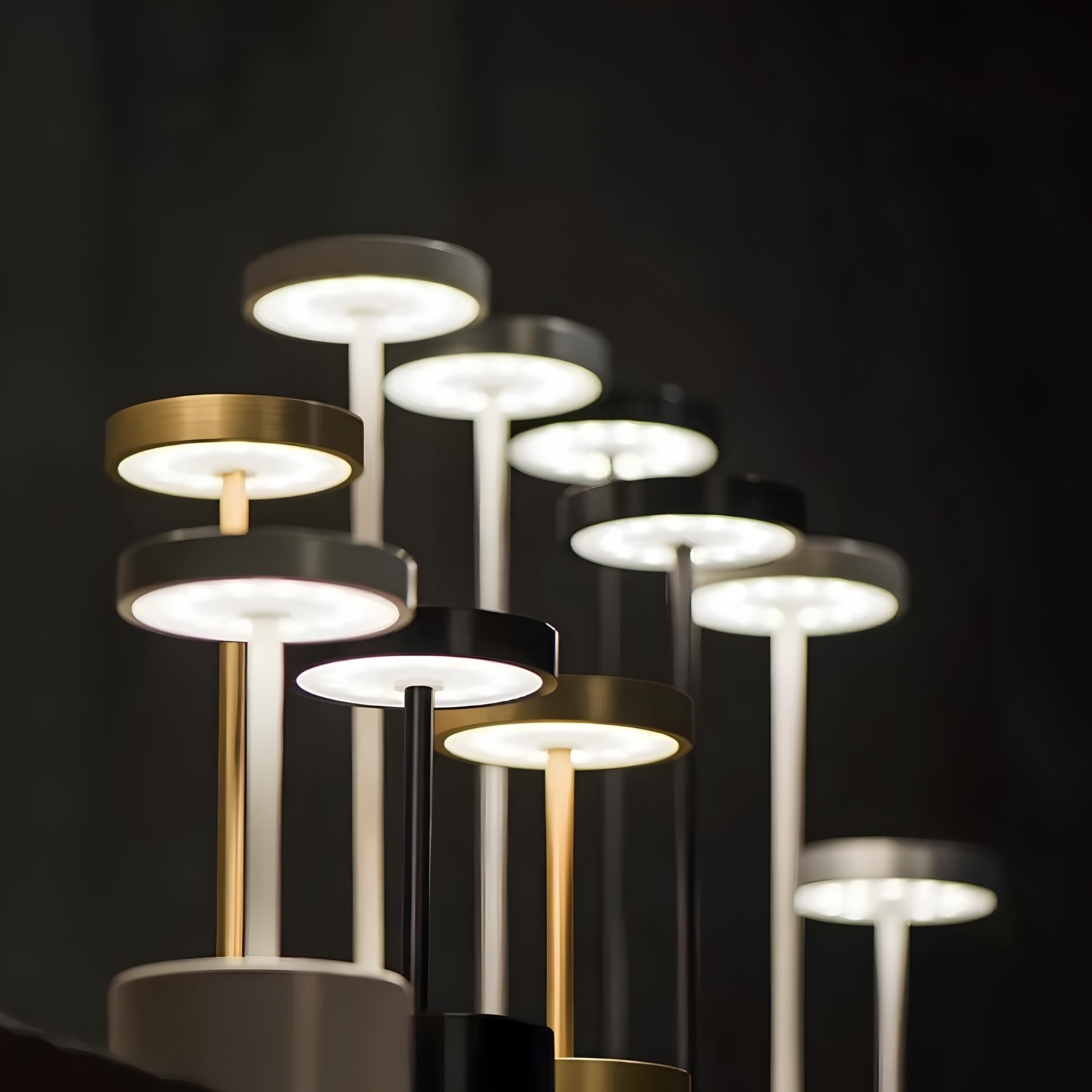 Modern table lamps with gold and black finishes on a dark background